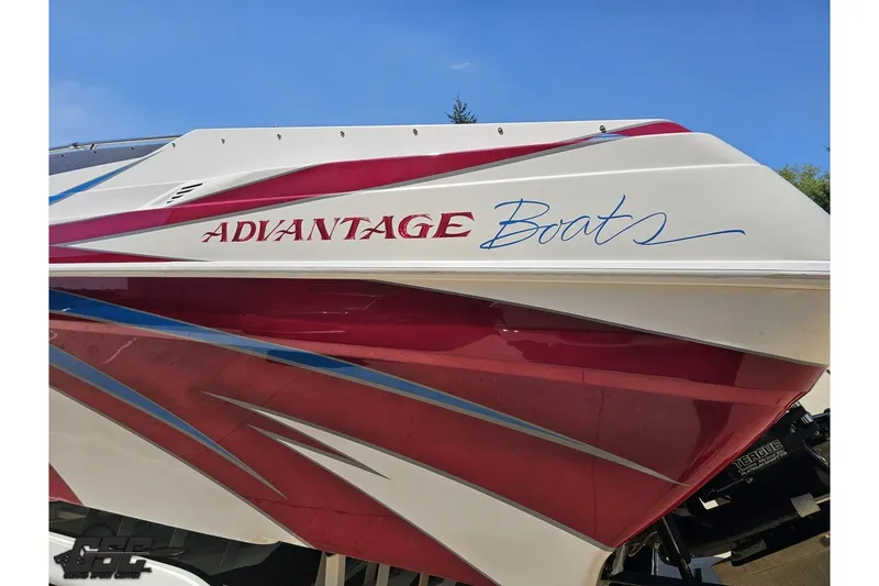 Slide: The Image of 2001 Advantage 34 Offshore boat with red and white design, featuring sleek graphics. - 23