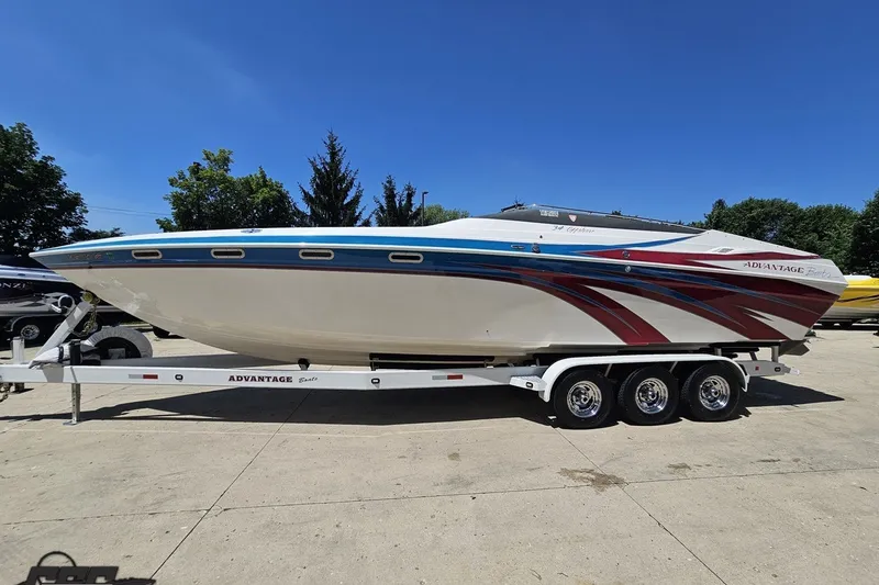 Slide: The Image of 2001 Advantage 34 Offshore boat on trailer, featuring sleek design and vibrant graphics. - 17