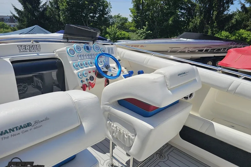 Slide: The Image of Interior of a 2001 Advantage 34 Offshore boat with white seating and blue accents. - 47
