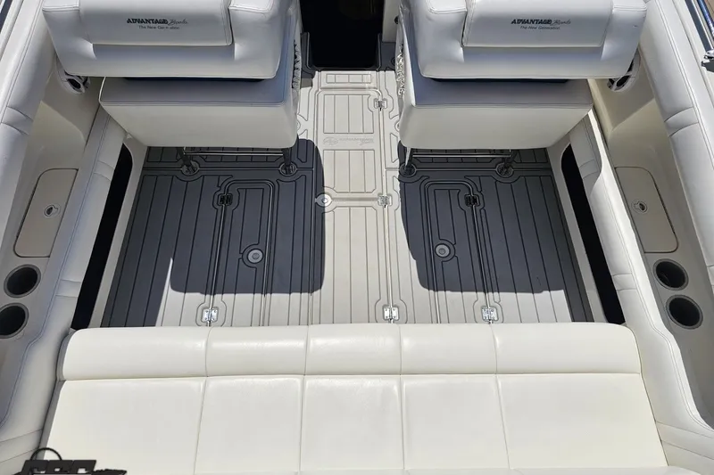Slide: The Image of Interior of a 2001 Advantage 34 Offshore boat with white seating and detailed flooring. - 42