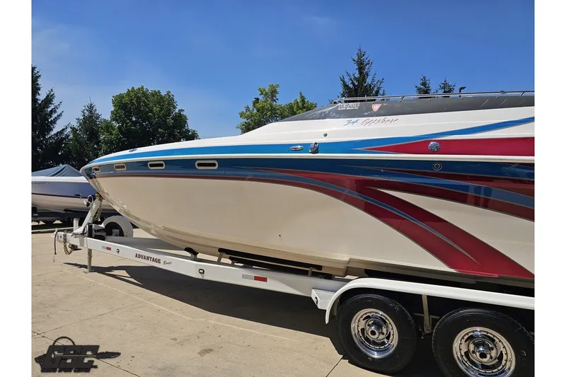 Slide: The Image of 2001 Advantage 34 Offshore boat on trailer, featuring vibrant red and blue graphics. - 21