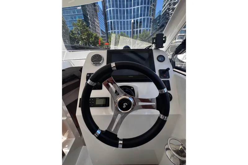Slide: The Image of Steering console of 2021 Beneteau Antares 8 boat with modern navigation equipment. - 16
