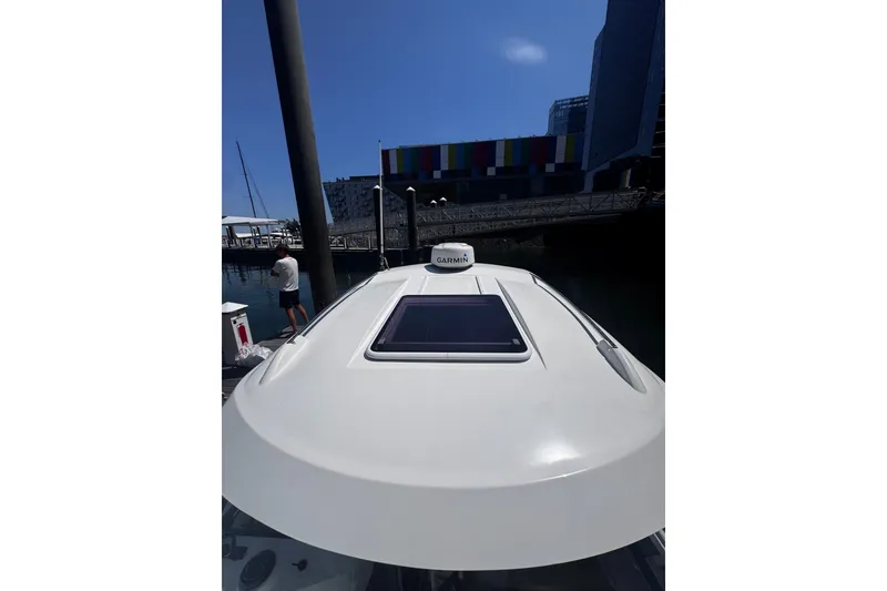 Slide: The Image of 2021 Beneteau Antares 8 docked, featuring Garmin equipment and modern design. - 31