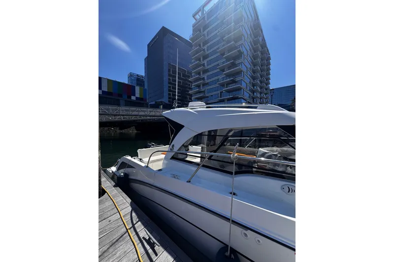 Slide: The Image of Beneteau Antares 8 boat docked near modern buildings, 2021 model. - 24