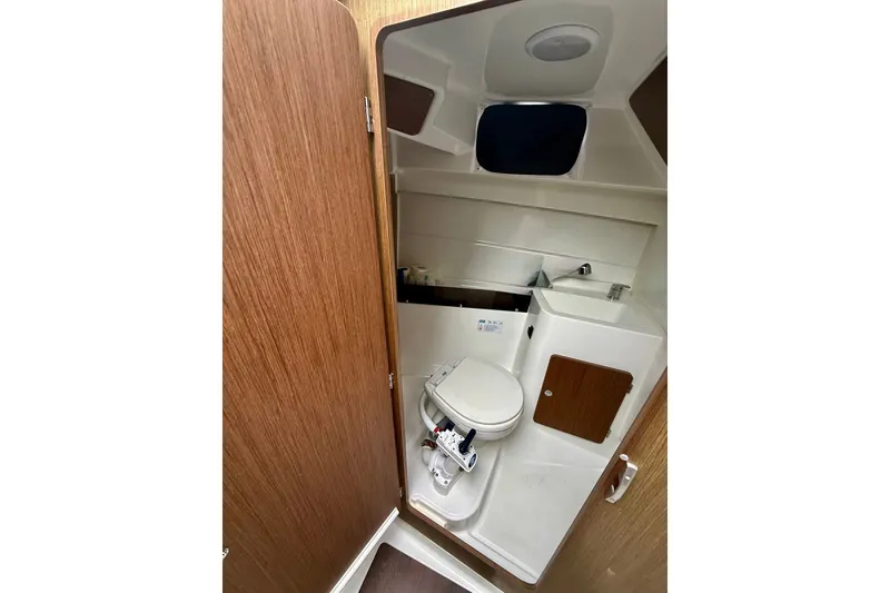 Slide: The Image of Compact bathroom in 2021 Beneteau Antares 8 boat, featuring toilet and sink. - 7
