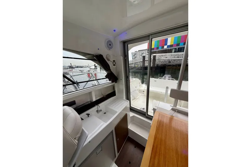 Slide: The Image of Interior view of 2021 Beneteau Antares 8 boat with sink and seating area. - 6
