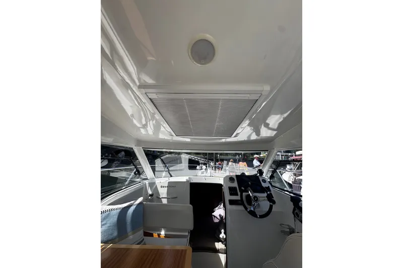 Slide: The Image of Interior view of 2021 Beneteau Antares 8 boat cockpit with steering wheel and seating. - 20