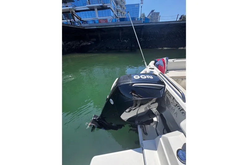 Slide: The Image of Outboard motor on a 2021 Beneteau Antares 8, docked in a marina. - 22