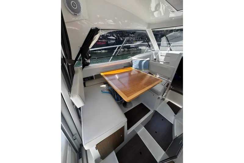 Slide: The Image of Interior of 2021 Beneteau Antares 8, featuring a wooden table and seating area. - 15