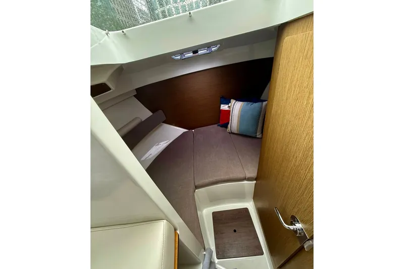 Slide: The Image of Cozy cabin interior of 2021 Beneteau Antares 8 with cushions and wooden accents. - 4