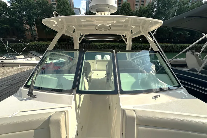 Slide: The Image of 2025 Boston Whaler 280 Vantage boat docked, showcasing sleek design and spacious seating. - 4