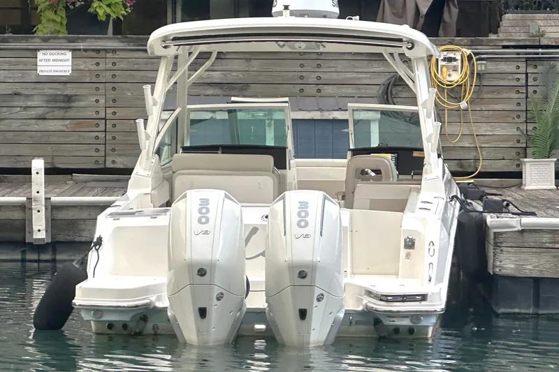 Slide: The Image of 2025 Boston Whaler 280 Vantage boat docked with twin 300 V8 engines. - 2