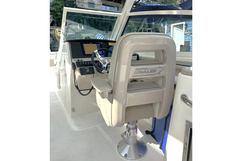 Slide: The Image of 2025 Boston Whaler 280 Vantage helm with modern controls and comfortable seating. - 7