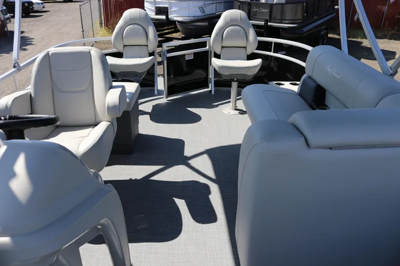 Slide: The Image of 2025 SunChaser Vista 20 Fish pontoon boat interior with plush seating and steering console. - 5