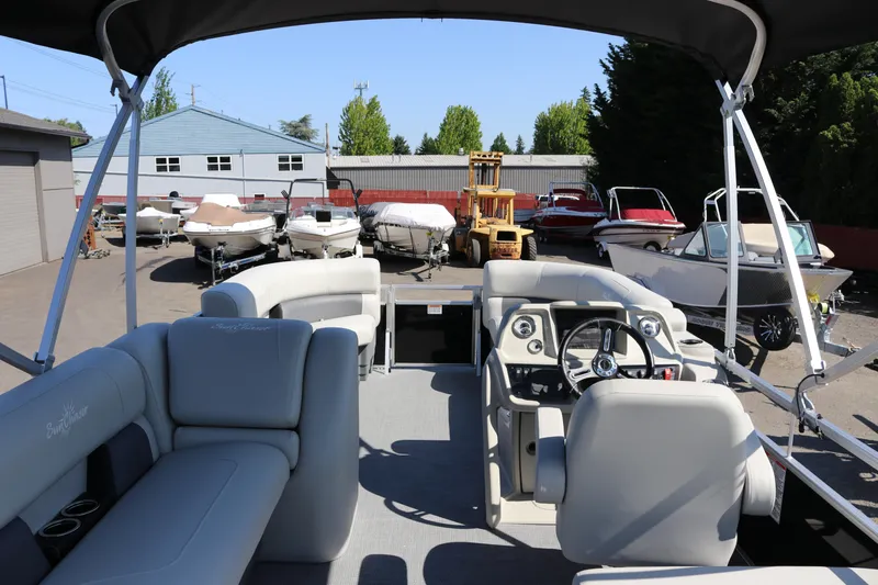 Slide: The Image of 2025 SunChaser Vista 20 Fish pontoon boat interior with steering console and seating. - 31