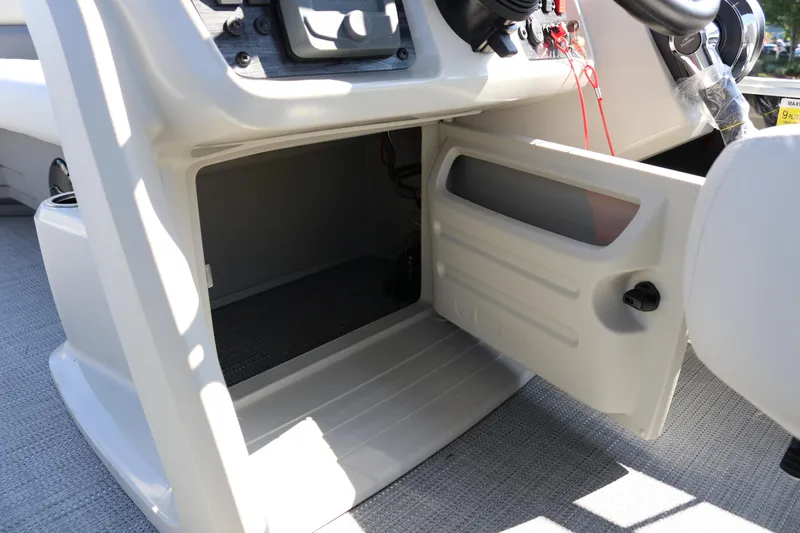 Slide: The Image of Open storage compartment on 2025 SunChaser Vista 20 Fish boat console. - 29