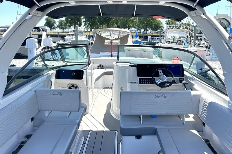 Slide: The Image of 2025 Sea Ray SDX 270 Surf boat interior with modern seating and steering wheel. - 8