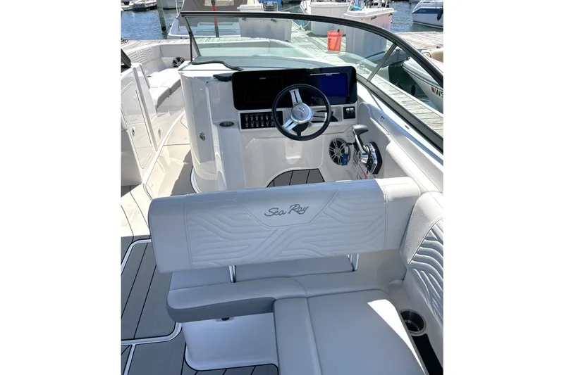Slide: The Image of 2025 Sea Ray SDX 270 Surf boat interior with sleek helm and luxurious seating. - 11