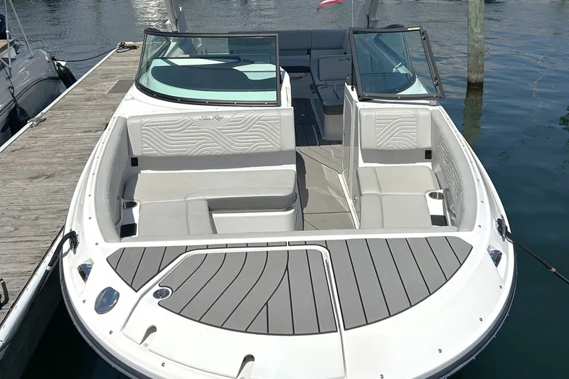Slide: The Image of 2025 Sea Ray SDX 270 Surf boat docked, featuring spacious seating and sleek design. - 3