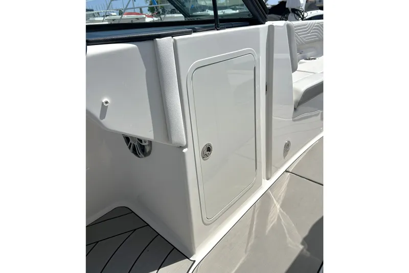 Slide: The Image of 2025 Sea Ray SDX 270 Surf boat interior, featuring sleek white paneling and seating. - 9
