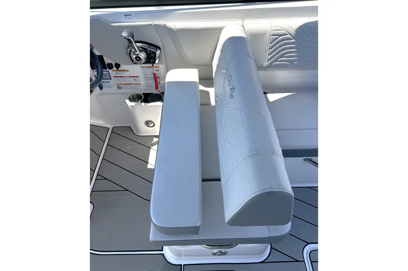Slide: The Image of 2025 Sea Ray SDX 270 Surf boat interior with white seating and control panel. - 12