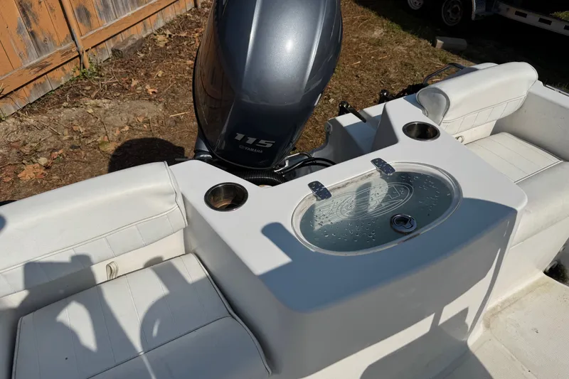 Slide: The Image of 2016 Sea Hunt Triton 188 boat interior with Yamaha 115 engine and seating area. - 9