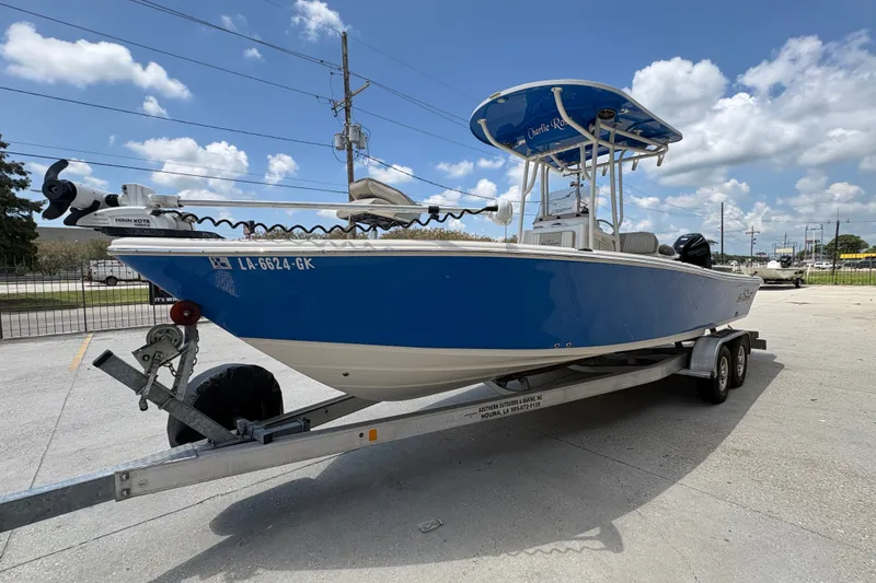 Slide: The Image of 2019 Sea Chaser 26 LX boat on trailer, blue hull, clear sky background. - 7