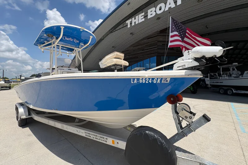Slide: The Image of 2019 Sea Chaser 26 LX boat on trailer, American flag, sunny day, dealership background. - 9
