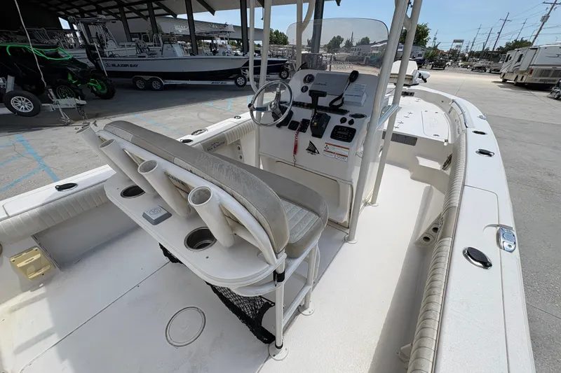 Slide: The Image of 2019 Sea Chaser 26 LX boat interior with helm, seating, and fishing rod holders. - 14