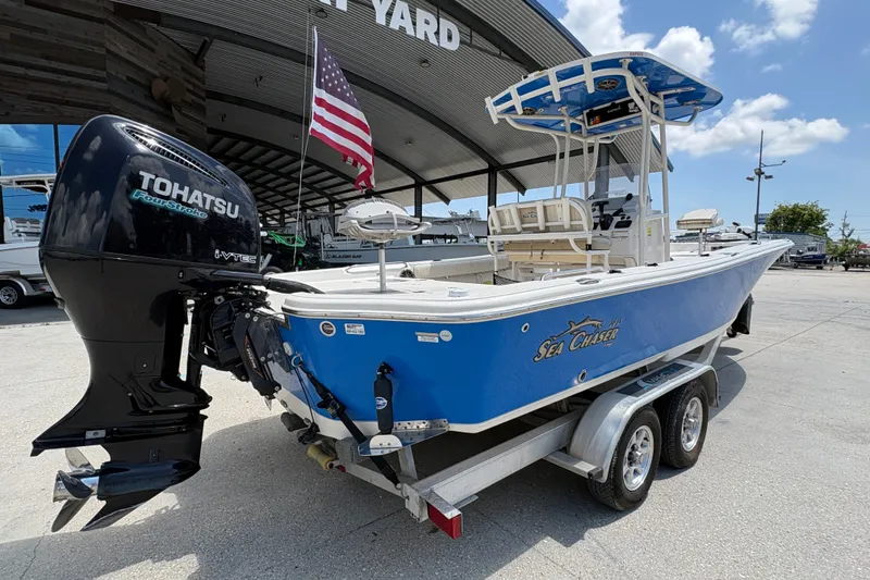 Slide: The Image of 2019 Sea Chaser 26 LX boat with Tohatsu engine on trailer, displayed outdoors. - 3