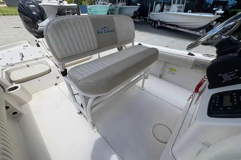 Slide: The Image of 2019 Sea Chaser 26 LX boat interior with seating and console, showcasing spacious design. - 15
