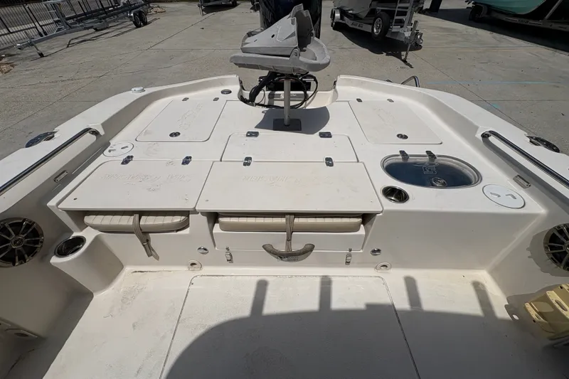 Slide: The Image of 2019 Sea Chaser 26 LX boat deck with storage compartments and fishing equipment. - 12