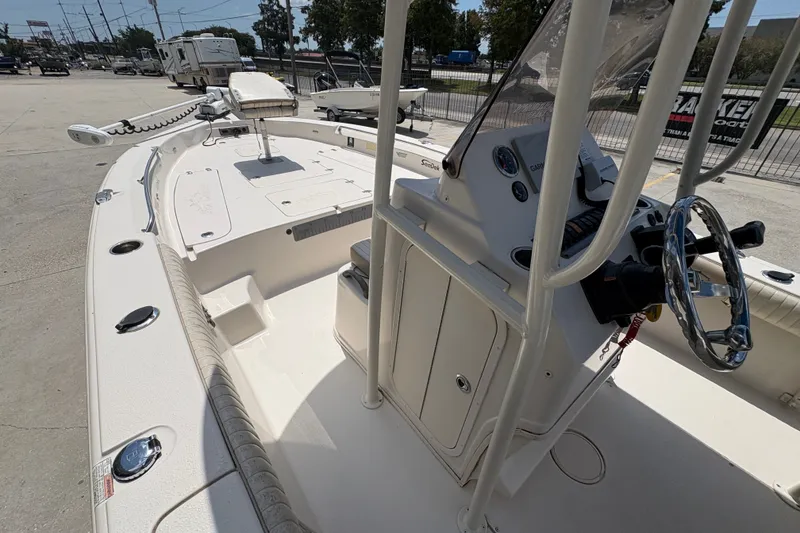 Slide: The Image of 2019 Sea Chaser 26 LX boat interior with steering console and seating area. - 17