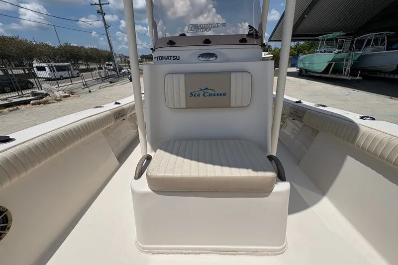 Slide: The Image of 2019 Sea Chaser 26 LX boat interior with cushioned seating and Tohatsu branding. - 18