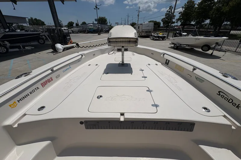 Slide: The Image of 2019 Sea Chaser 26 LX boat deck with fishing gear and brand logos. - 19