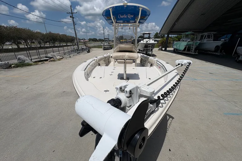 Slide: The Image of 2019 Sea Chaser 26 LX boat with trolling motor, parked outdoors under a blue sky. - 10