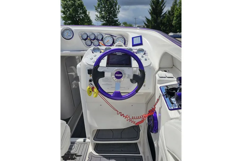 Slide: The Image of 2007 Sunsation 32 Dominator boat dashboard with purple steering wheel and gauges. - 58
