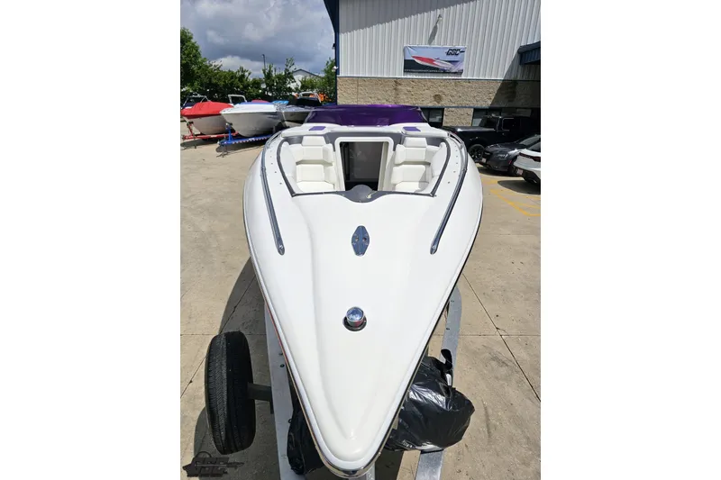 Slide: The Image of 2007 Sunsation 32 Dominator boat on trailer, white exterior, parked outdoors. - 15