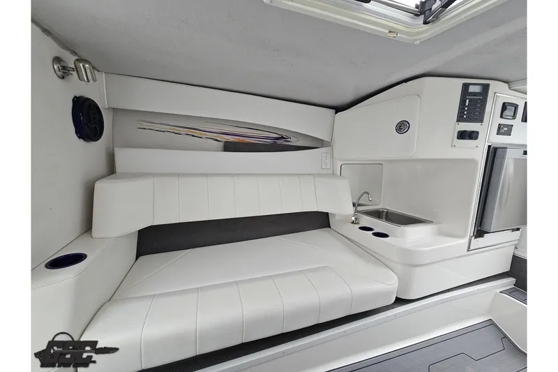 Slide: The Image of Interior of 2007 Sunsation 32 Dominator boat with white seating and compact kitchenette. - 70