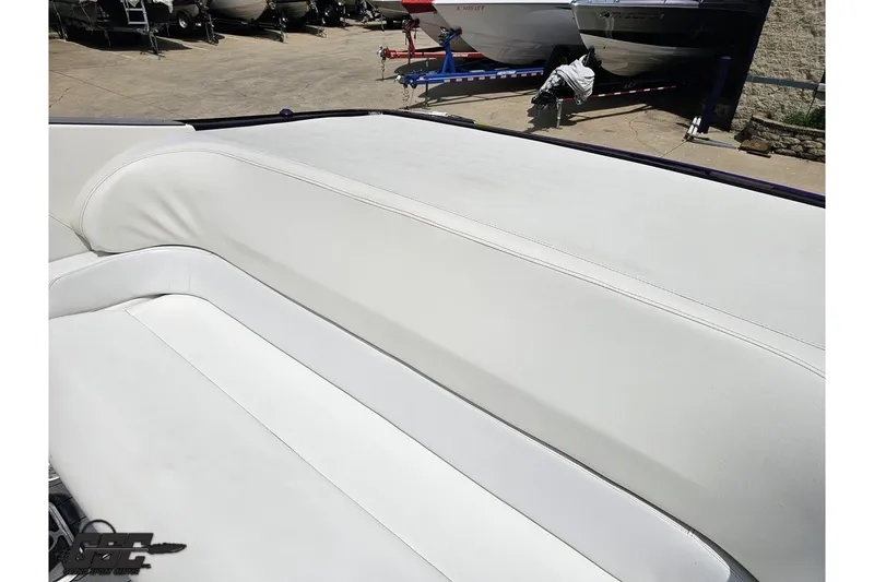 Slide: The Image of 2007 Sunsation 32 Dominator boat with white leather seating, docked outdoors. - 43