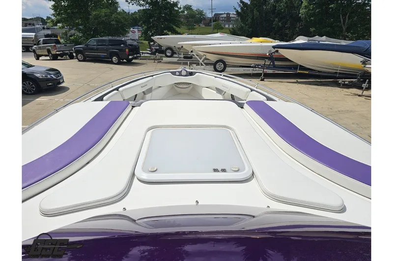 Slide: The Image of 2007 Sunsation 32 Dominator boat with purple accents, parked in a marina. - 61