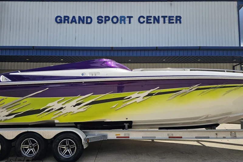 Slide: The Image of 2007 Sunsation 32 Dominator boat with vibrant purple and yellow design at Grand Sport Center. - 4