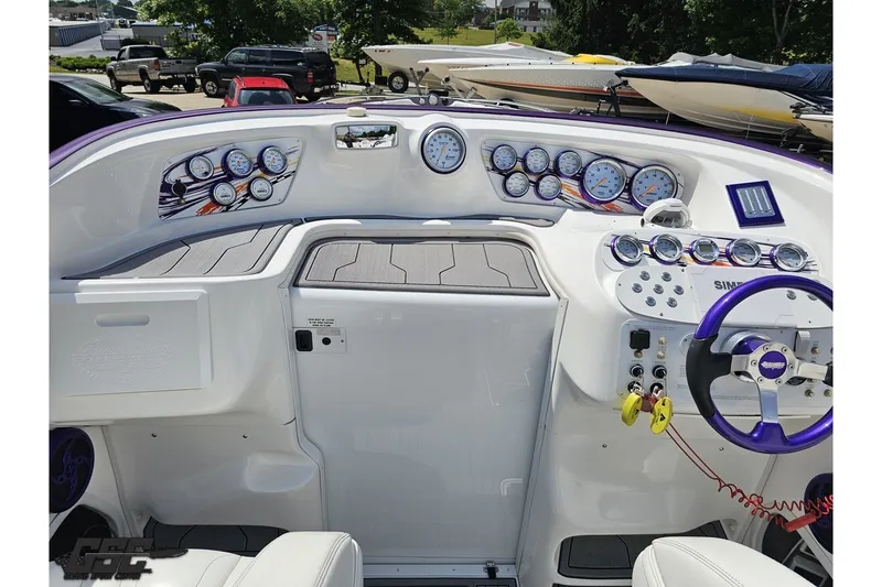 Slide: The Image of 2007 Sunsation 32 Dominator boat dashboard with gauges and controls, featuring a purple steering wheel. - 60
