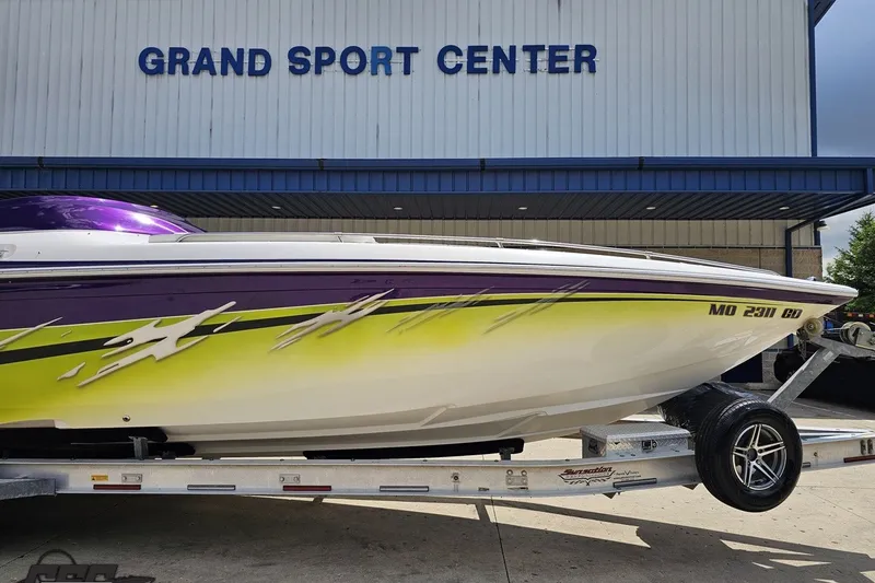 Slide: The Image of 2007 Sunsation 32 Dominator boat with vibrant graphics at Grand Sport Center. - 12