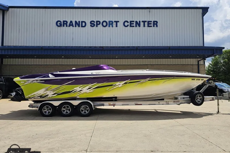 The Image of 2007 Sunsation 32 Dominator boat with vibrant graphics at Grand Sport Center. - 1