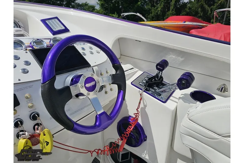 Slide: The Image of 2007 Sunsation 32 Dominator boat cockpit with purple steering wheel and controls. - 57