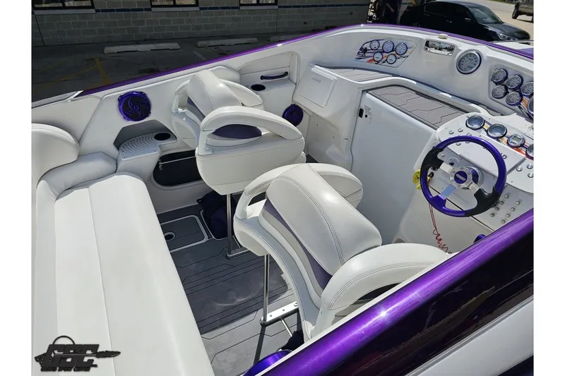Slide: The Image of 2007 Sunsation 32 Dominator boat interior with white seating and purple accents. - 42