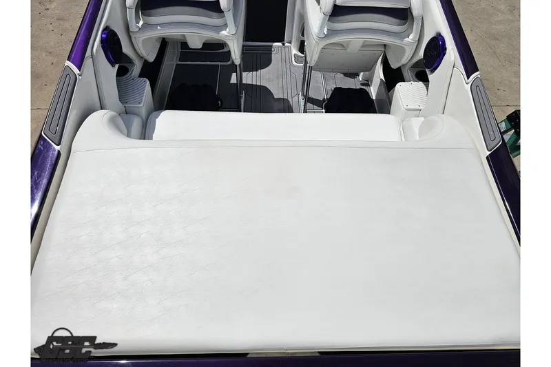 Slide: The Image of 2007 Sunsation 32 Dominator boat interior with white seating and purple accents. - 38
