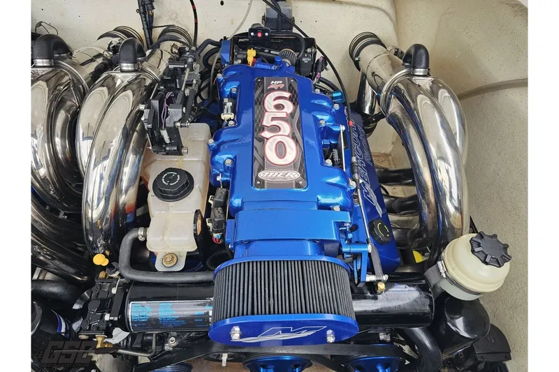 Slide: The Image of 2007 Sunsation 32 Dominator engine with blue Mercury 650 HP motor and chrome exhaust. - 100