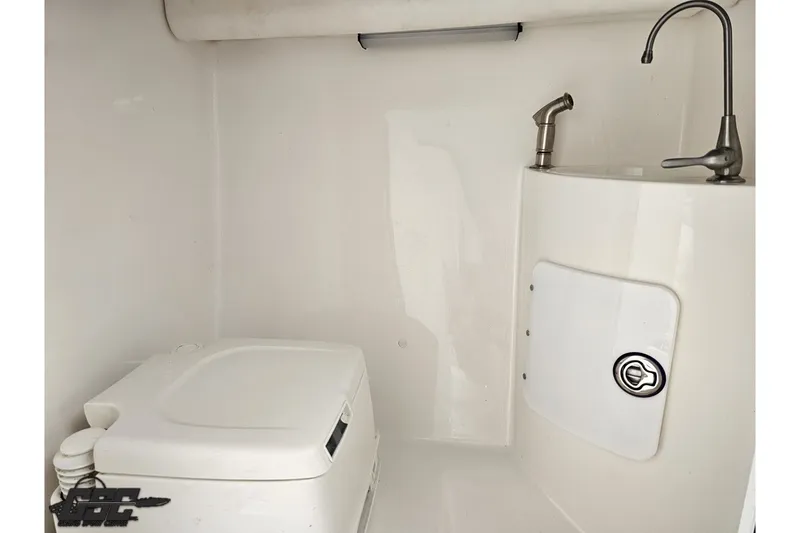 Slide: The Image of 2007 Sunsation 32 Dominator boat interior with compact toilet and sink. - 77